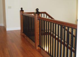 Custom railing featuring both wood and wrought iron and custom iron newel post.