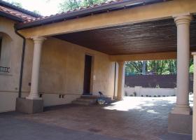 Covered car portico with stamped colored concrete.