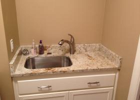 After: granite counter-top and splash, sink and faucet.