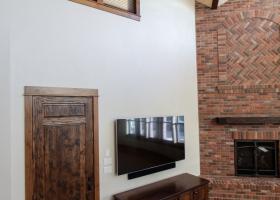 Floor-ceiling brick fireplace with unique mantle